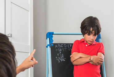 Child receiving a star for showing good behavior in class